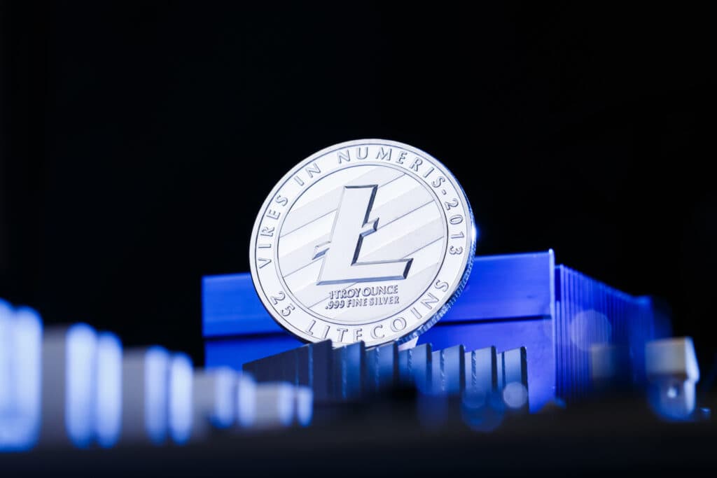 litecoin and processor on blue background